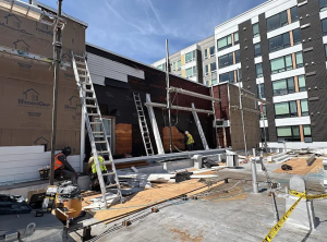 Final Touch Construction LLC crew performing exterior siding replacement and structural work on a commercial building rooftop in King County.