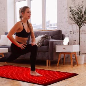 Consumer using Wondear red light therapy device at home