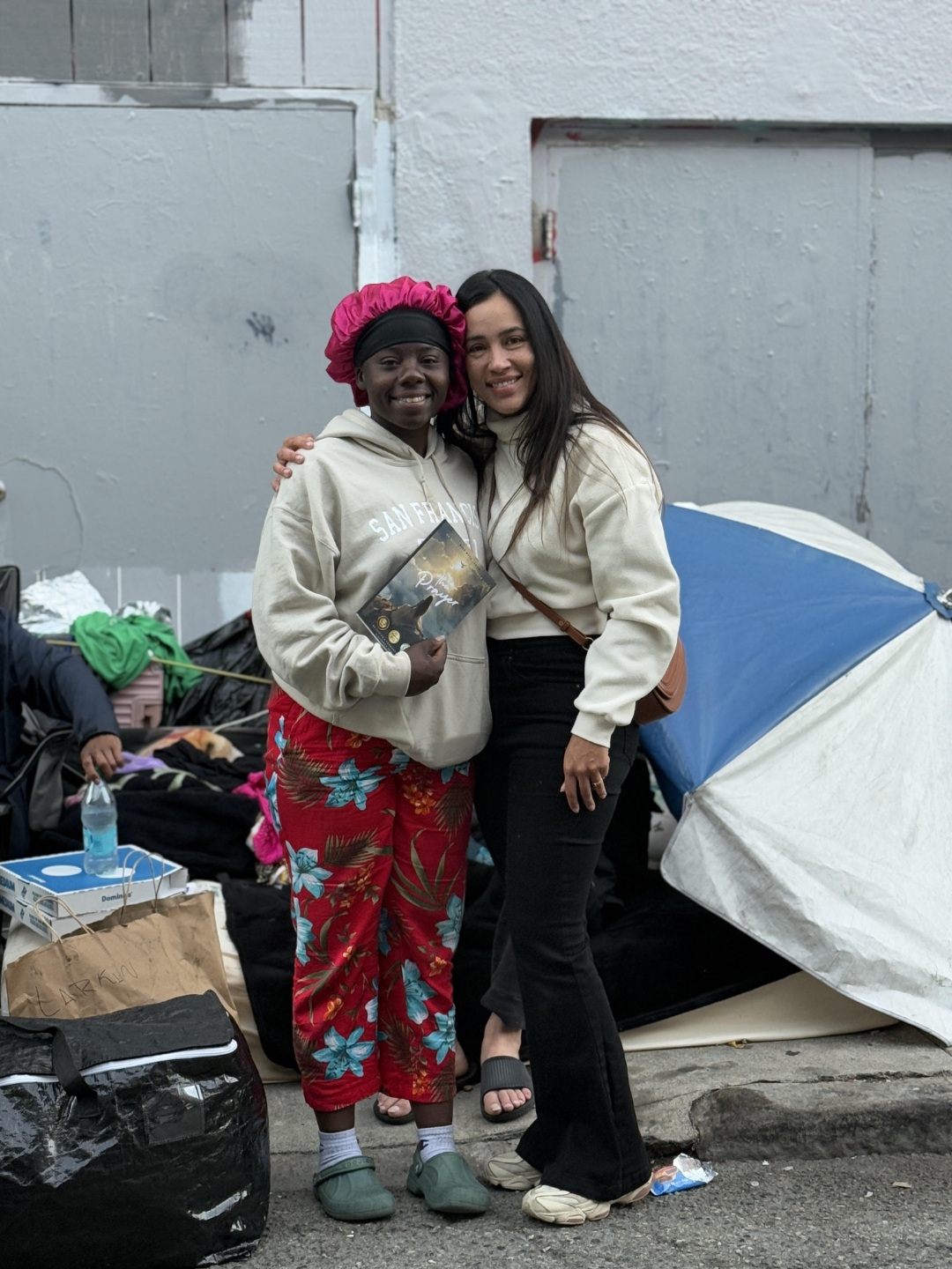 From #1 Bestseller to the Tenderloin: Alexander Debelov and Stefania Leão Give Away Books to San Francisco’s Unhoused
