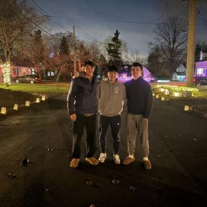 Alex Finkelstein, Matthew Petersen, and Ronan Moon celebrating a successful luminary night