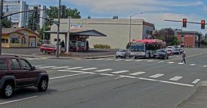 Image of man in Cross walk at red light with car approaching