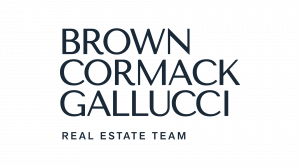 Typographic logo reading "BROWN CORMACK GALLUCCI REAL ESTATE TEAM" in dark navy uppercase letters against a white background.