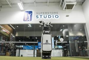 A golf bag of PXG products sits in front of the PGA TOUR Superstore Studio section of the national retail store.