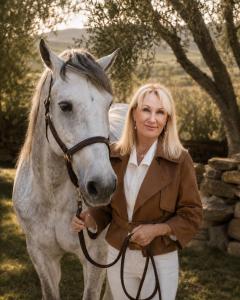 Celeste with her horse Freckles standing in the olive grove