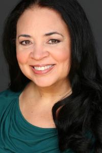 Author Tonya Fitzpatrick wearing an emerald green top and smiling in her headshot.