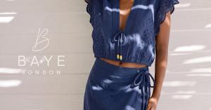 Model wearing Blue Brodier trimmed top and wrap skirt