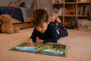 Child reading a Coco the Little Bear Cub Book