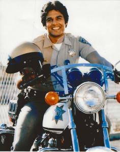 Iconic photo of Erik Estrada as Officer “Ponch” Poncherello in the hit television series CHiPs, smiling on his California Highway Patrol motorcycle.