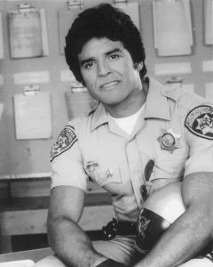 Erik Estrada portraying Ponch on CHiPs, wearing his iconic California Highway Patrol uniform in a vintage promotional image from the classic television series.