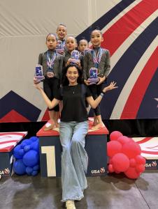 Athletes trained by rhythmic gymnastics coach Iryna Bielkina swept the podium at the American Championship, held in Miami, Florida, taking first, second, and third place among 72 competitors from clubs across the country Coach Iryna Bielkina with her students Zhuban Azhar, Gasparyan Nicole, and Gu Avery after sweeping the podium at the American Championship in Miami.