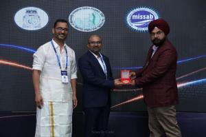 Dr. Rao receiving the COSSCON 2026 Best Paper Gold Medal during the PASMISS–MISSABCON–COSSCON scientific meeting in Chennai, with conference organisers on stage.