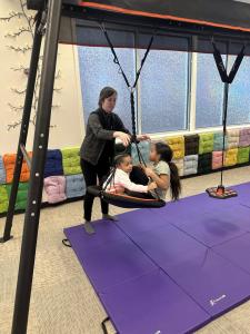 President Vanessa Roddam plays with a guest at David's Clubhouse