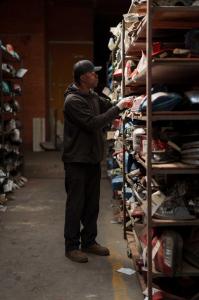 Select Auto Parts employee locating an automotive part on warehouse shelving inside the Milwaukee facility.