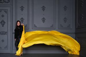 Karen Goslin, MSW, psychotherapist and best-selling author of Yellow Paint, photographed with flowing yellow fabric for her September 2026 Best Holistic Life Magazine feature on mental health, accountability, and lasting change.