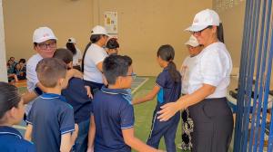 Plushie Planet volunteers hugging schoolchildren in navy uniforms