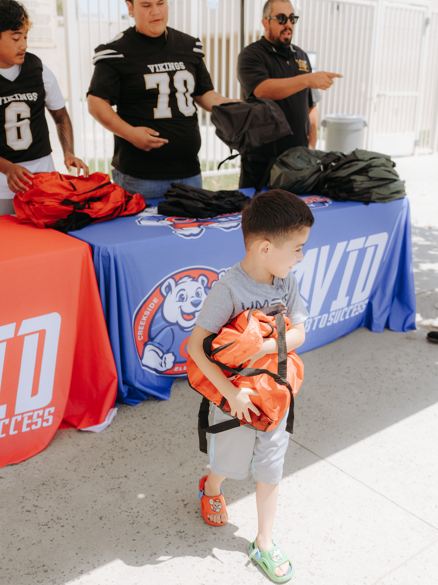 Aptia Continues Aptia Serves Initiative with Back-to-School Bookbag Drive Alongside Star Football Players