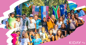group of kids at international summer camp smiling and hugging like a family