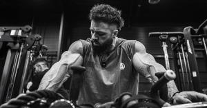 Regan Grimes rests between sets at Pure Muscle + Fitness as the ANIMAL team films behind-the-scenes content during his training session.
