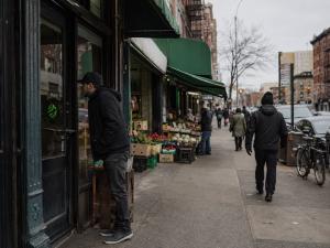 Brooklyn neighborhood street with local businesses and pedestrians representing the Secret World local creator network.