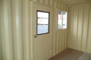 Shipping container with man door and windows