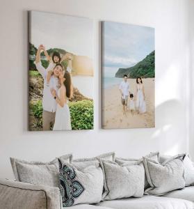 Two custom family vacation photos printed on canvas and displayed above a sofa.