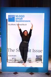 Natasha Broxton standing inside a magazine-style Goldman Sachs 10,000 Small Businesses event display.
