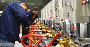 Workers at Zhejiang Lushyong Machinery’s production facility testing agricultural sprayer pumps to ensure quality before shipment.