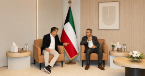 Vahe Daghlian and Krikor Totondjian of DTS Solution seated together with the Kuwait flag in a Kuwait office meeting room