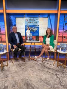 Author Mark C. Fava discusses his new children's book, Andy the Admiral and the USS Shipshape, during a recent television appearance, with copies of the book displayed on the set.