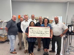 Fisher Barton team presents check to Waukesha Food Pantry