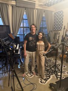 Producer Spearfisher and vocalist Farrah Mechael smiling together inside a professional recording studio during production of “Remembrance.”