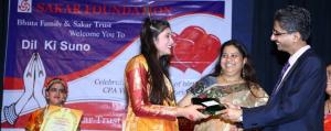 Hiten Bhuta presenting an award to a participant on stage during Sakar Foundation’s Dil Ki Suno program.