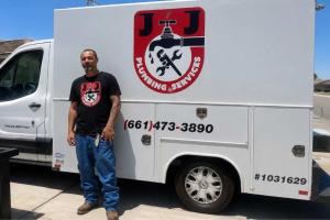 Kern County property owners face a combination of aging housing infrastructure, water-conservation pressures and documented ground-movement conditions that make the condition of buried plumbing an increasingly important consideration for homeowners, buyers and property managers Natalio Pergis, owner of J&J Plumbing Services, standing next to a company service van in Bakersfield, California, displaying the business logo.