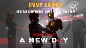 Promotional image for Ferryman Collective and Virtual Worlds Company’s Uncanny Alley: A New Day, featuring live performers in VR headsets alongside the characters Gh0st and Atom, with text announcing its Emmy nomination for Outstanding Emerging Media Prog