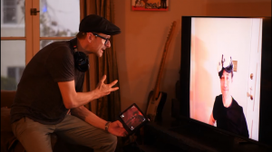 Stephen Butchko directs actor Brendan Bradley during a remote rehearsal for Uncanny Alley: A New Day, using a tablet and video call while coordinating the live VR performance.
