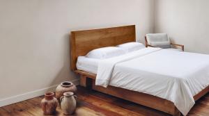 Bamboo bedding is often presented as if the plant name tells the whole story White bamboo lyocell bedding on a wooden bed in a minimalist bedroom