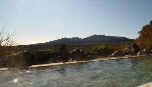 The open-air hot spring bath at Oshima Onsen Hotel, looking out to Mt. Mihara.
