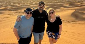 Jason Bare, Aviraj Puri, and Michele Jowdy of BARE International standing together in a desert landscape.