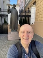 Dr Kokenyesi in front of Ferenc David Statue