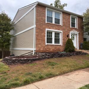 Completed natural stone retaining wall with proper drainage and grading, built by Eagle Eye Construction in Reston, VA