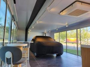 Pulse Container expandable pod interior with covered car, seating and track lighting | The Clear Idea