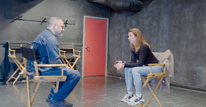 Gil Bellows sits across from an acting participant during a Scene Study workshop, discussing performance in a VFS studio.