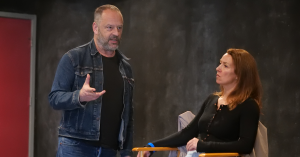 Gil Bellows stands beside an acting participant seated in a director’s chair during a Scene Study workshop at Vancouver Film School.