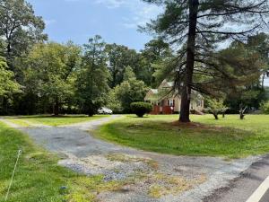 3 BR/1.5 BA Cape Cod-style home w/walk-out basement on 2.15 +/- acres minutes from historic downtown Gordonsville, VA (Louisa County) • The home measures 2,479 +/- gross sf. and features one bedroom and half bath on the main level and 2 bedrooms