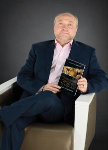 Vadim Dekhtyar holding his book “Conquering Fear: The Path of Inner Strength” against a dark professional background.
