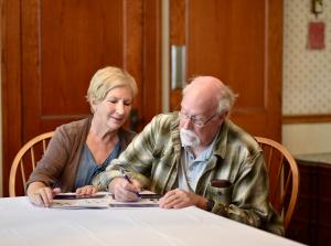 Older couple reviewing paperwork together at a table