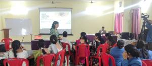 Royal Trinity School in Itarsi, Madhya Pradesh, a speaker presents a session discussing why mental health is crucial during the cyber safety and security seminar hosted by Dr. Matthew K. Thomas. Dr. Michael Thomas and his wife Dr. Praisey Thomas, nee Yesudas.