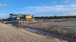 Workers use heavy machinery to clear the construction site.