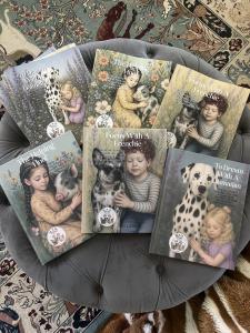 A display of the books in the H.A.K Heroes series, which includes "Focus With a Frenchie," "To Dream With a Dalmatian" and "The Helping Hoof."