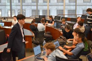 Zachary Schwartz working with students during a financial literacy lesson